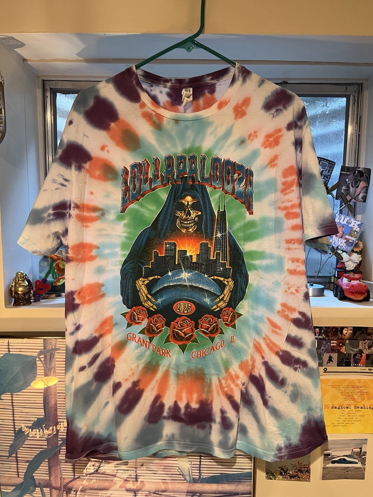 Lollapalooza 2025 multicolored tie dye shirt with list of the performers on back