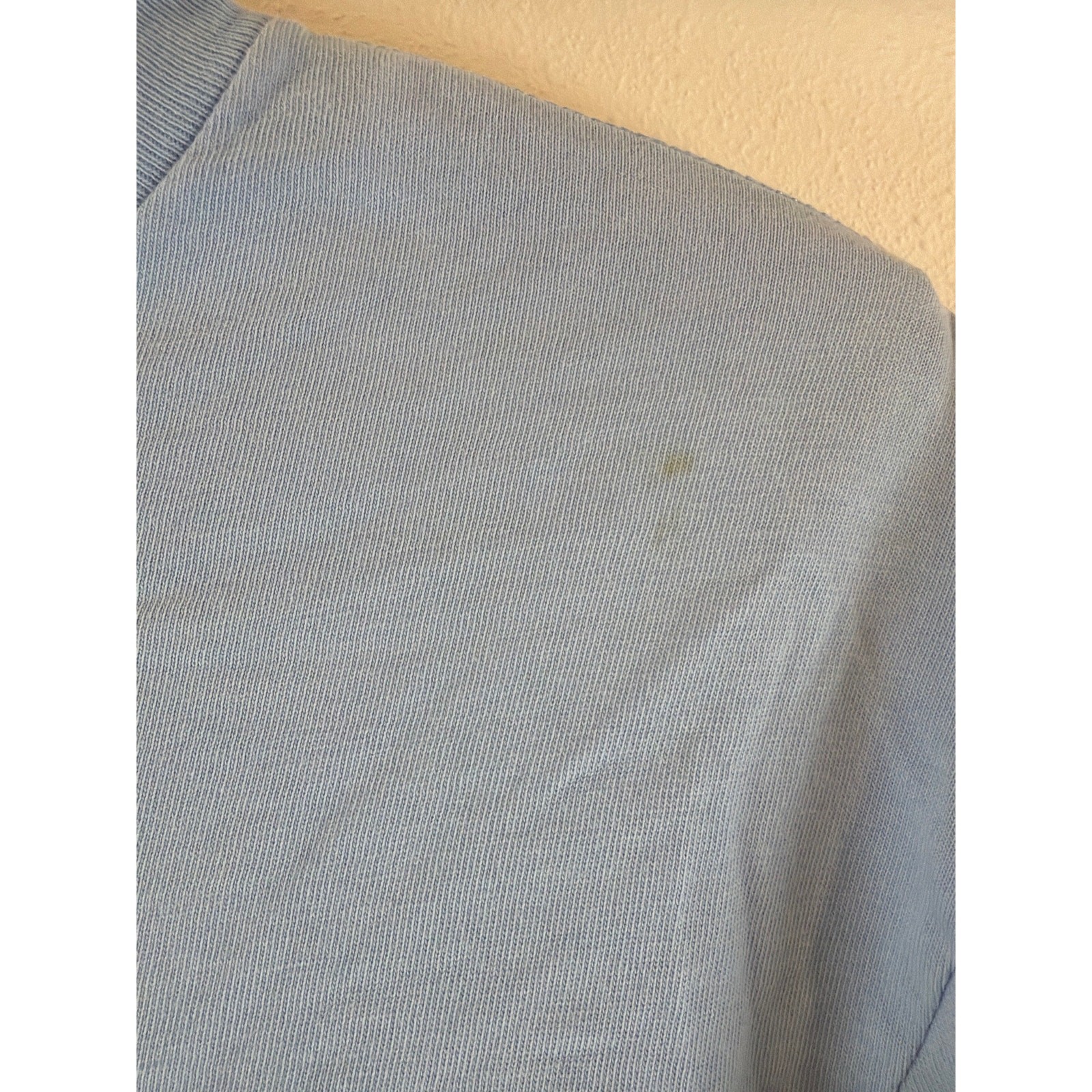 Sky blue long sleeve tee with logo on pocket and sleeve.