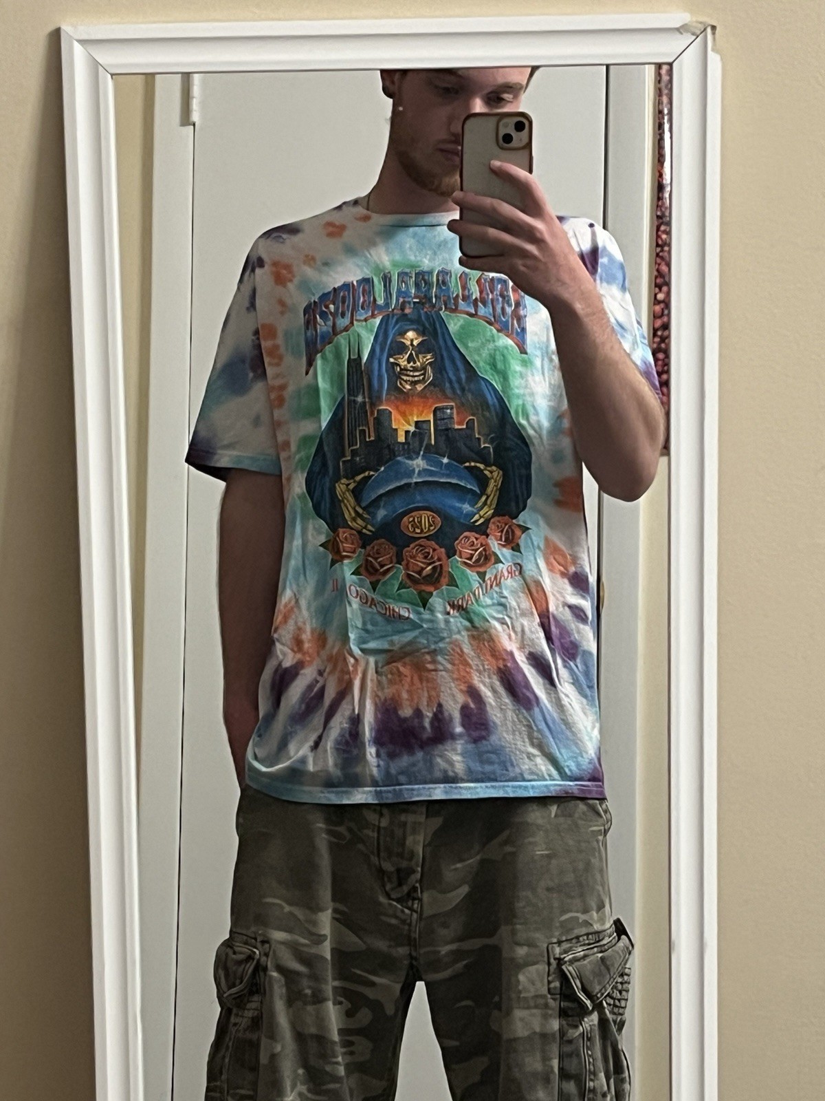 Lollapalooza 2025 multicolored tie dye shirt with list of the performers on back